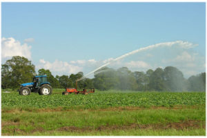 Tractor in Field farm spray pesticide