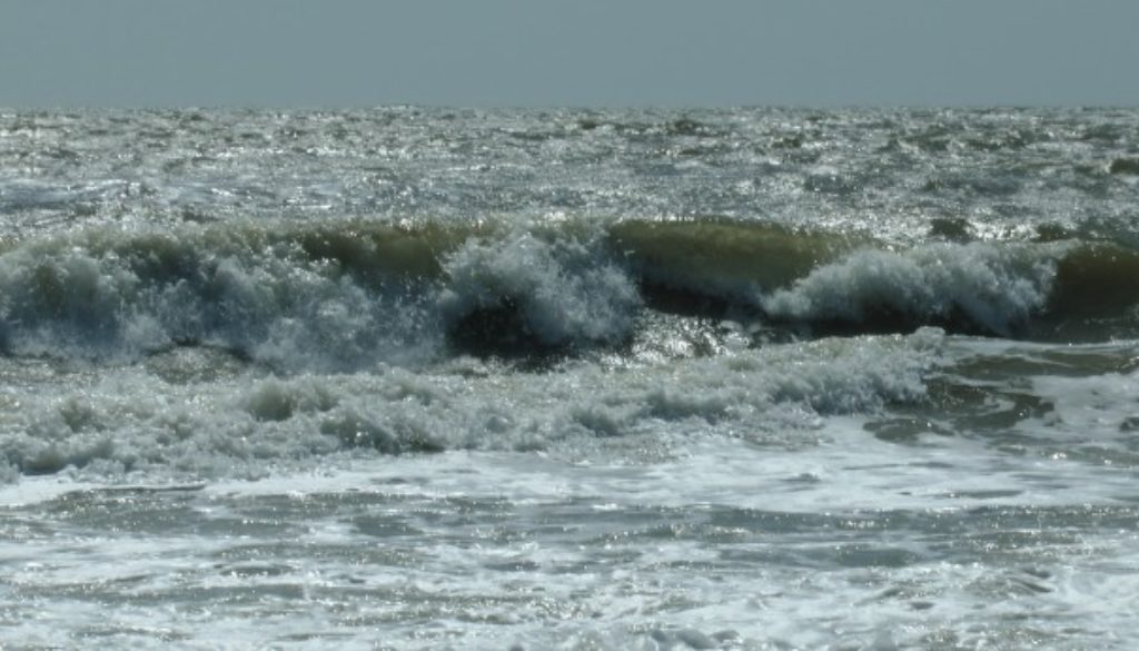 ocean waves crash sea foam pollution