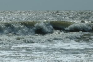 ocean waves crash sea foam pollution